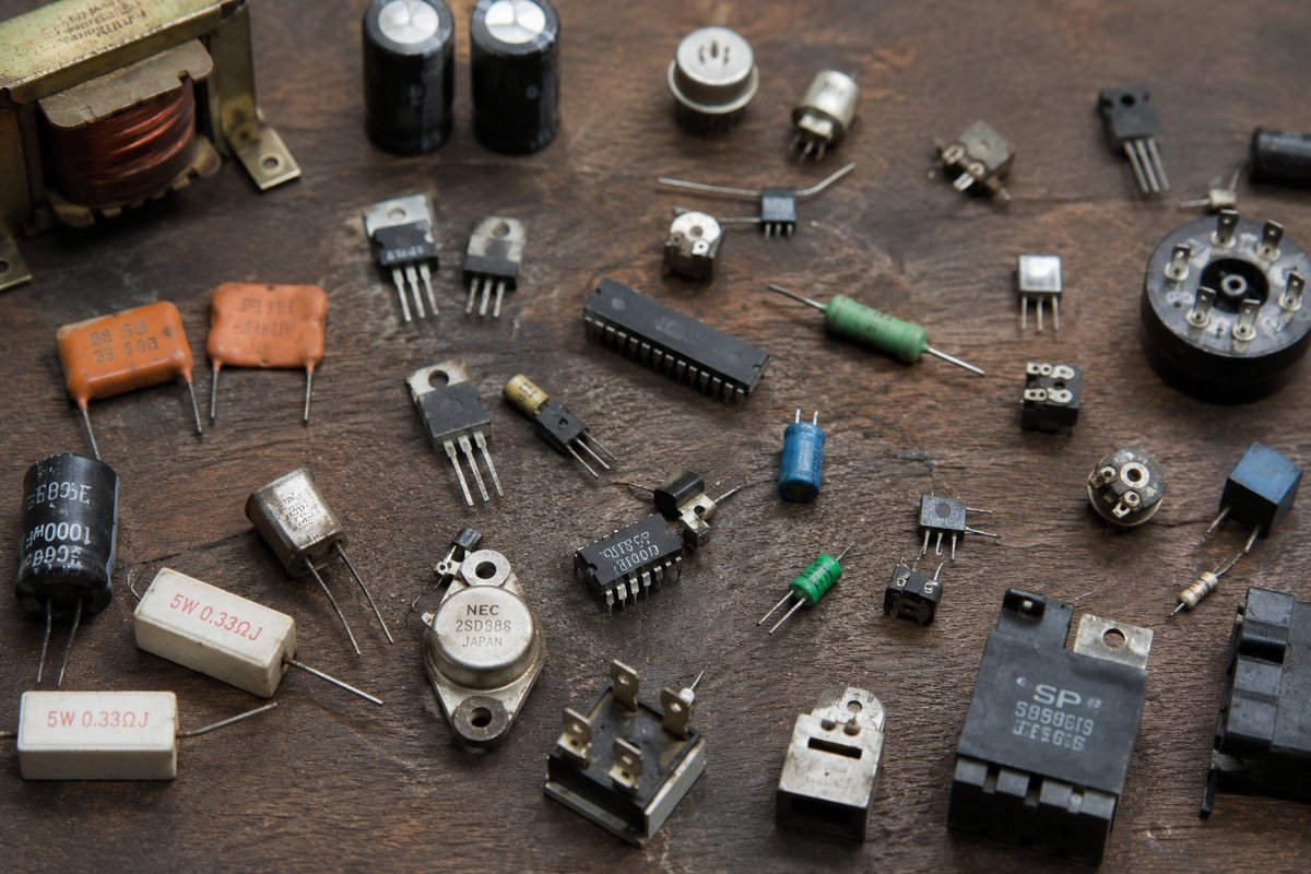 Used and surplus electronic components laid out for sorting and resale